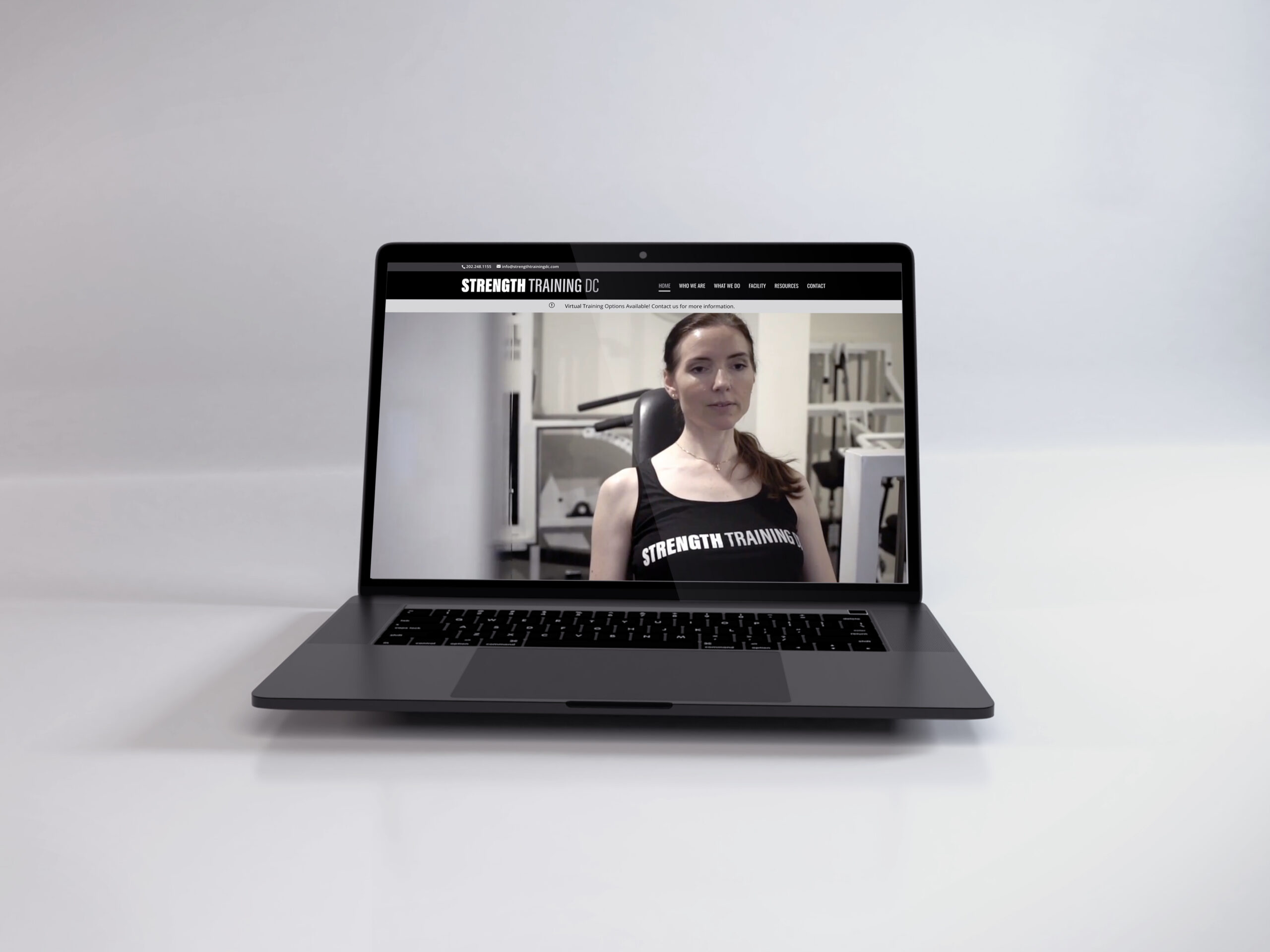 Laptop showing the Strength Training DC website Laptop showing the Strength Training DC website